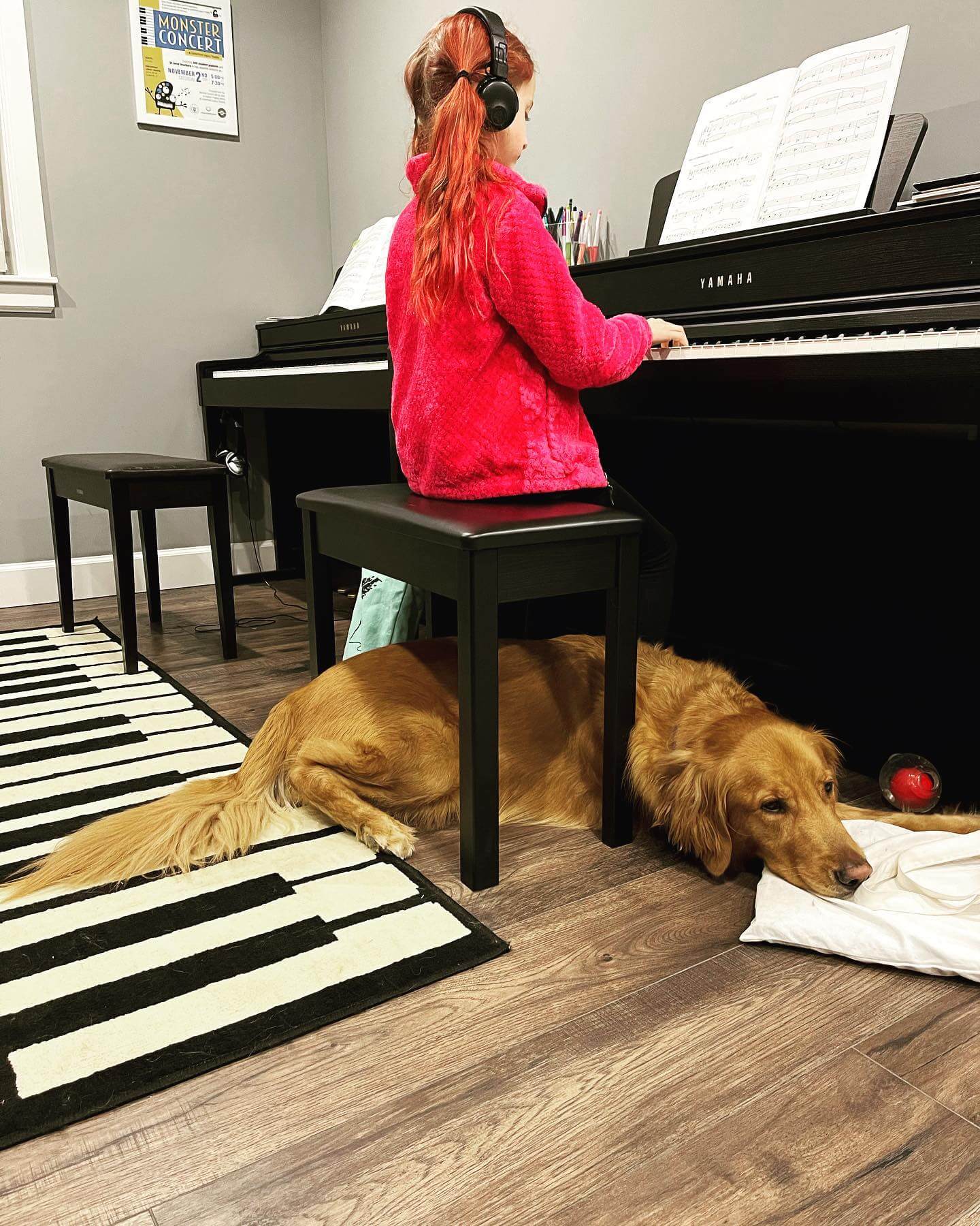 young girl playing piano with headphones on